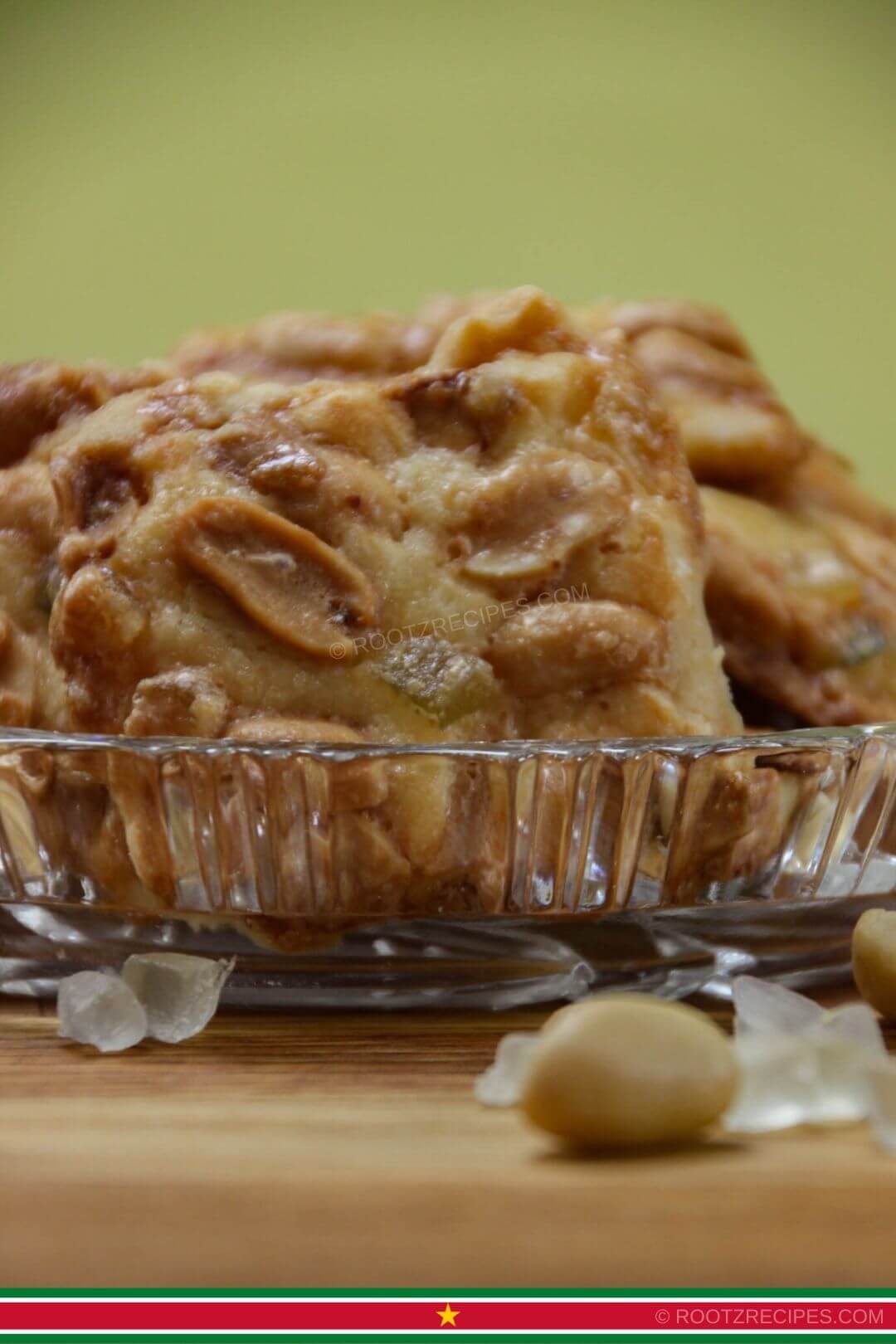 adolfina cookies in a shallow glass bowl with peanut and succade in the foreground