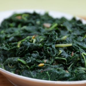 close-up of cooked klaroen in a white dish with a green background